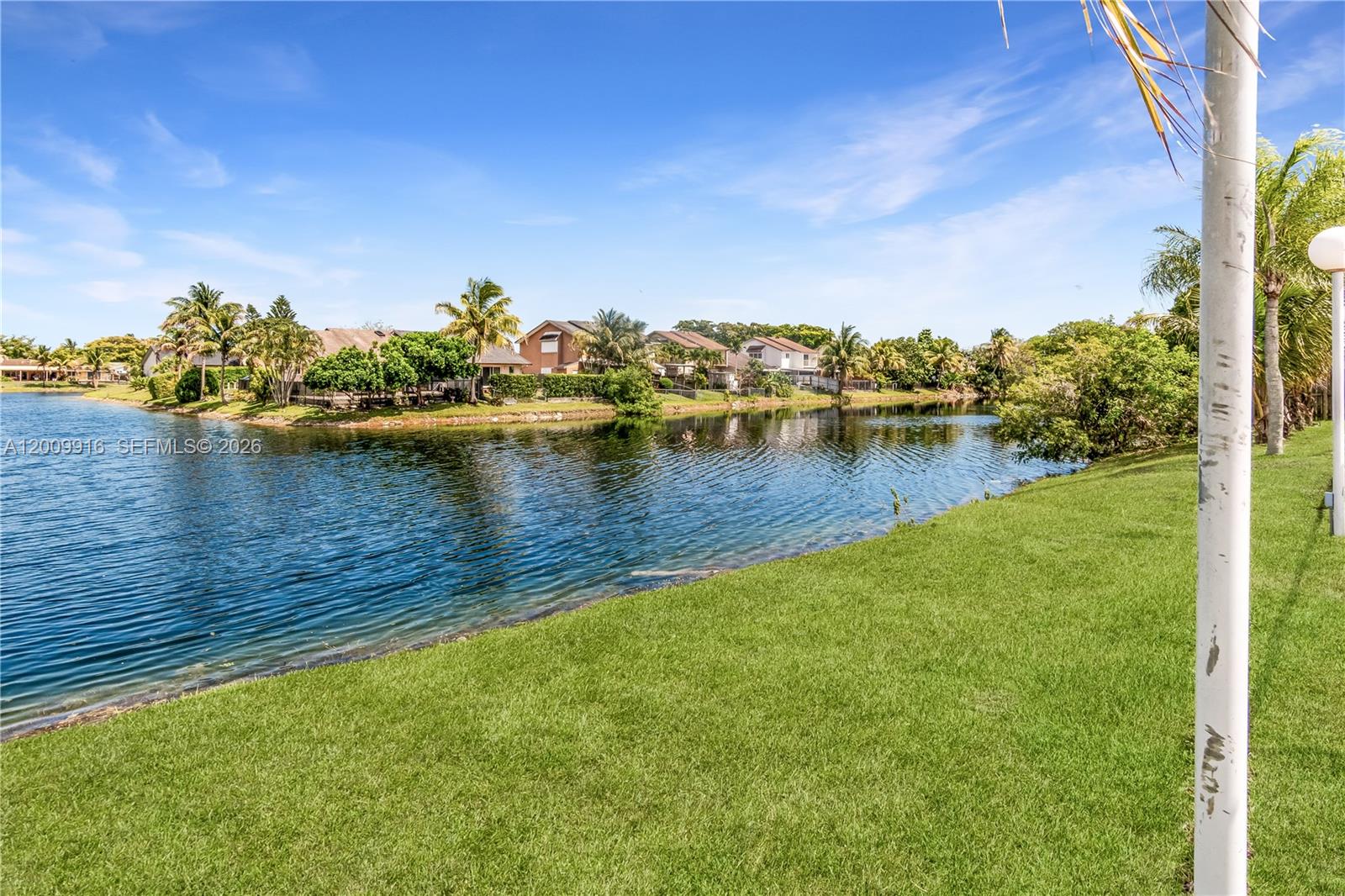 14905 Southwest 80th Street, Unit 212 Miami, FL 33193 - Photo 9 of 37 a view of a lake with houses in back
