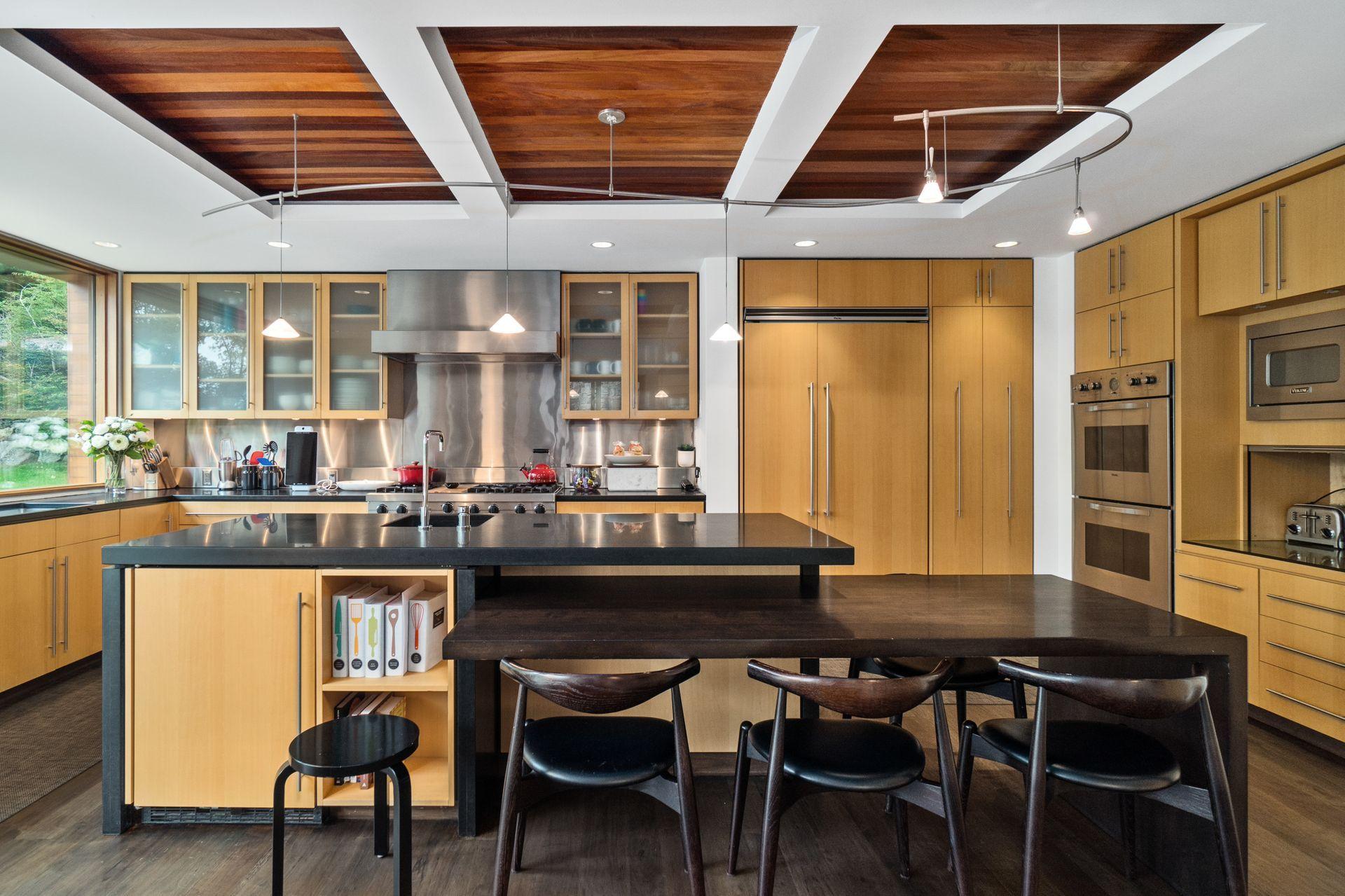 81 Cross Ridge Road New Canaan, CT 06840 - Photo 13 of 49 a kitchen with a table chairs and wooden floor