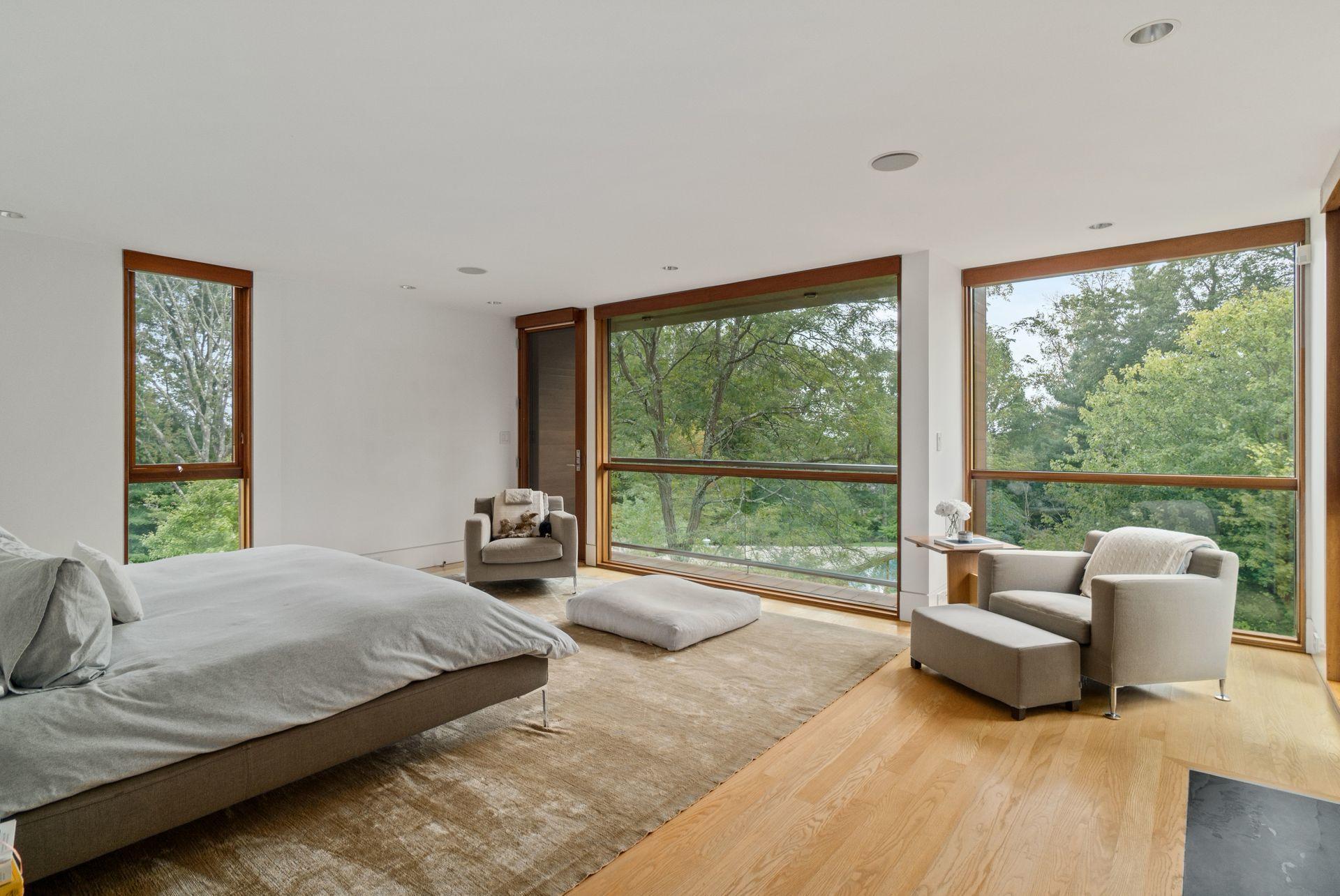81 Cross Ridge Road New Canaan, CT 06840 - Photo 17 of 49 a spacious bedroom with a bed and a large window
