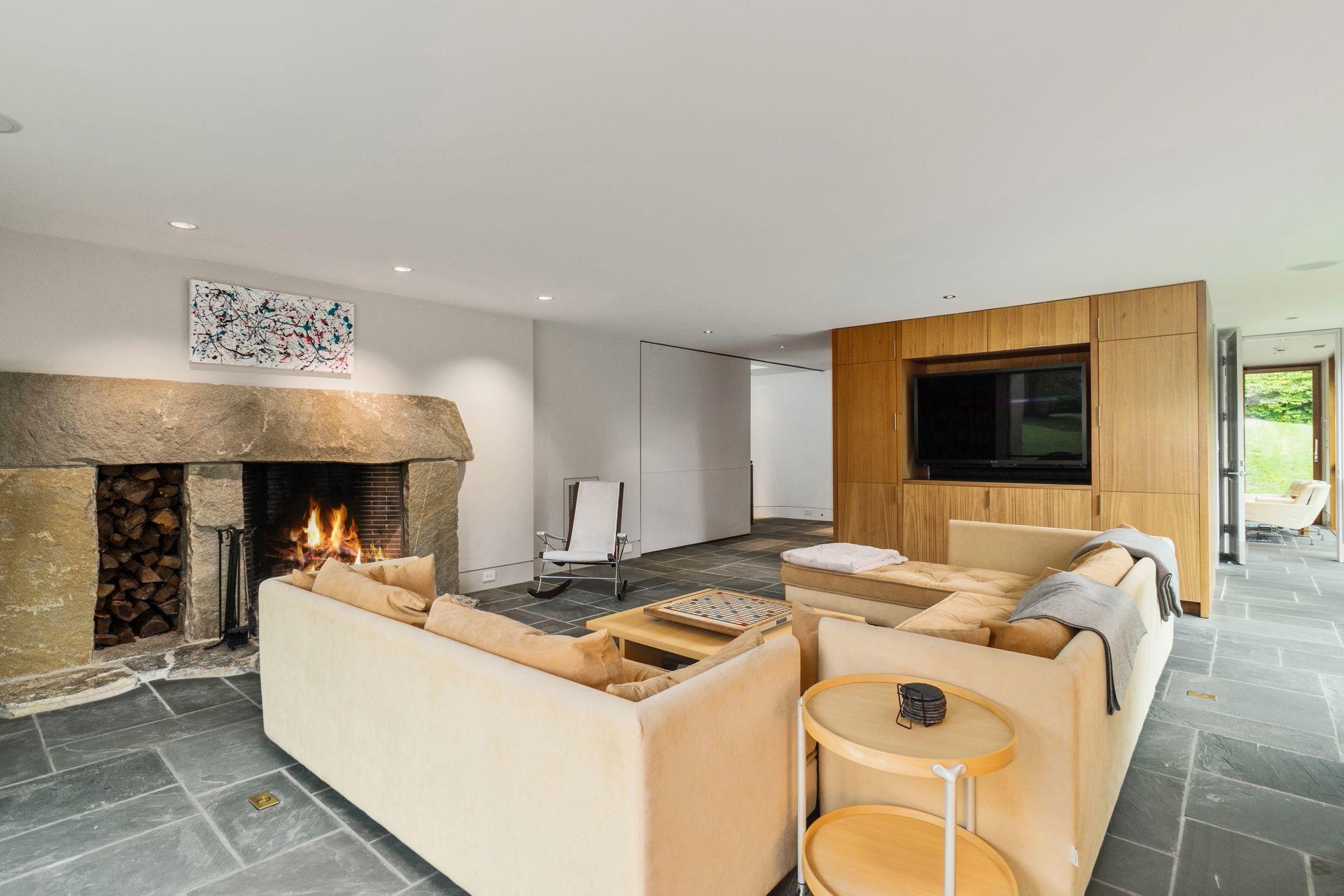 81 Cross Ridge Road New Canaan, CT 06840 - Photo 25 of 49 a living room with furniture and a flat screen tv
