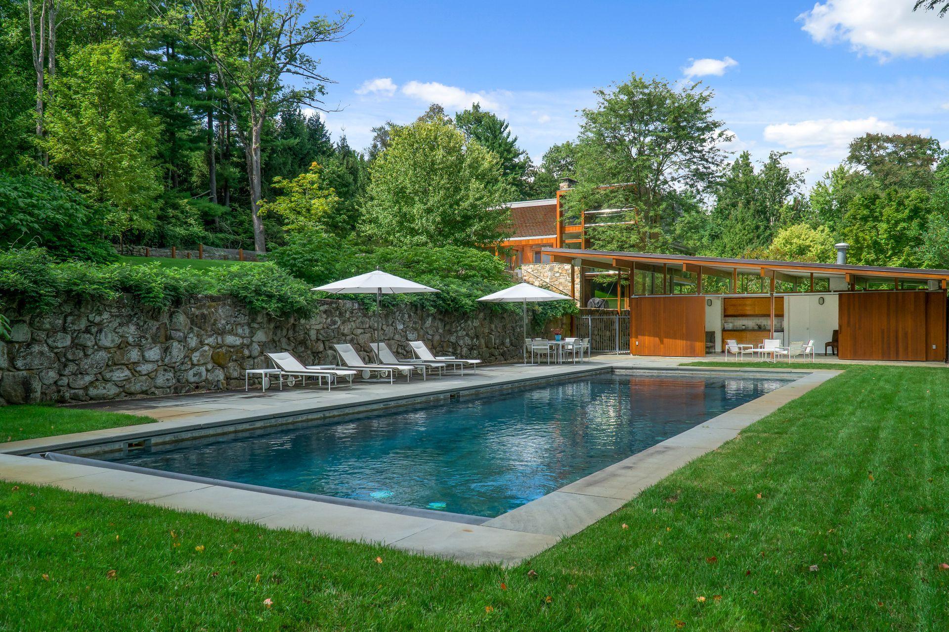 81 Cross Ridge Road New Canaan, CT 06840 - Photo 37 of 49 a view of a house with pool and a yard