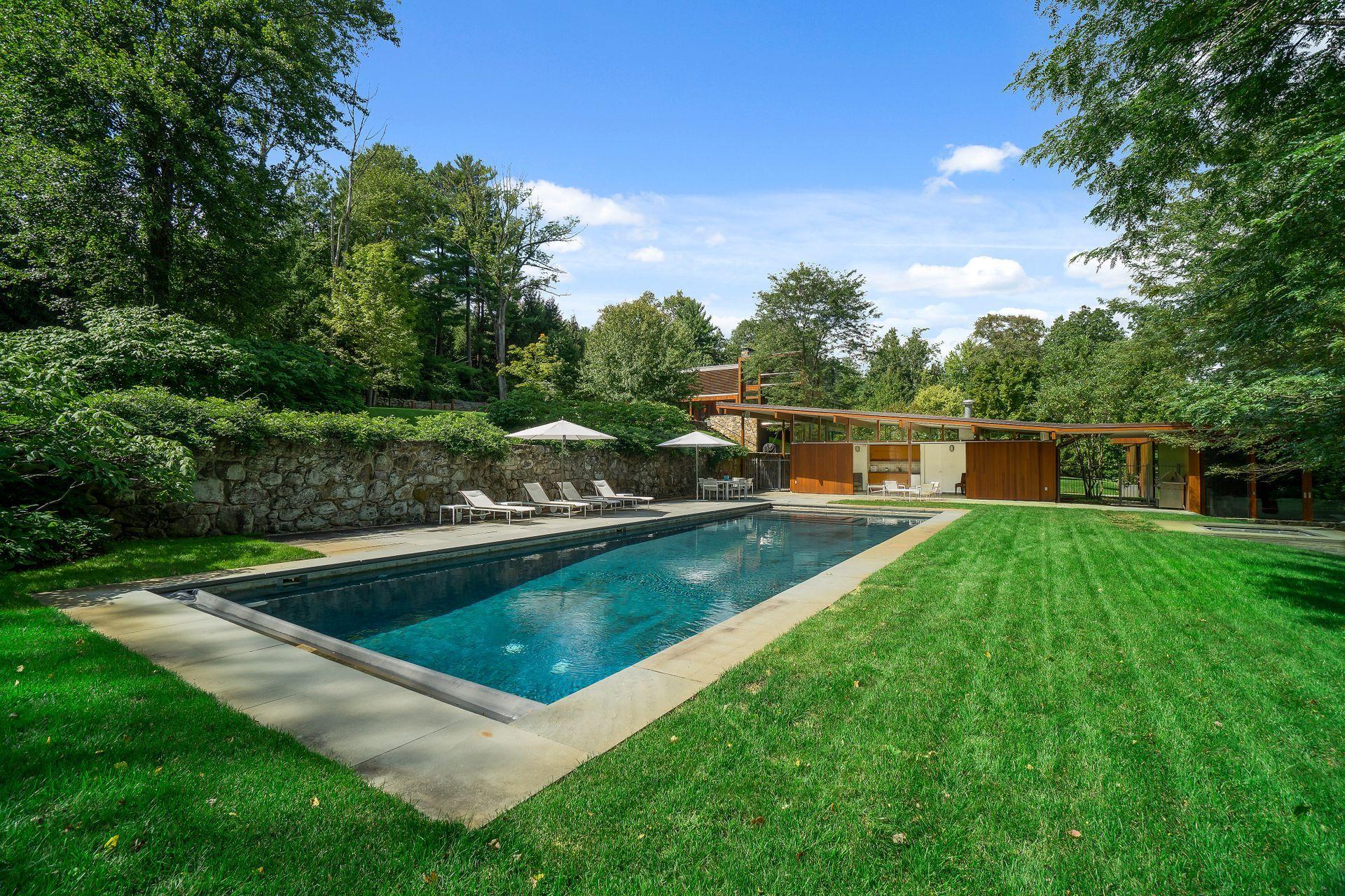 81 Cross Ridge Road New Canaan, CT 06840 - Photo 41 of 49 a view of a swimming pool with a patio