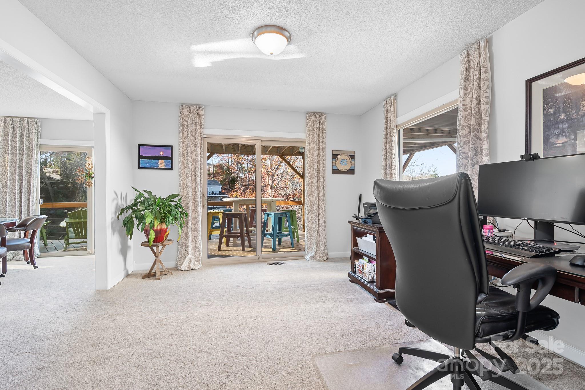 9044 Spanish Wells Court Tega Cay, SC 29708 - Photo 21 of 48 a view of a livingroom with workspace and a window