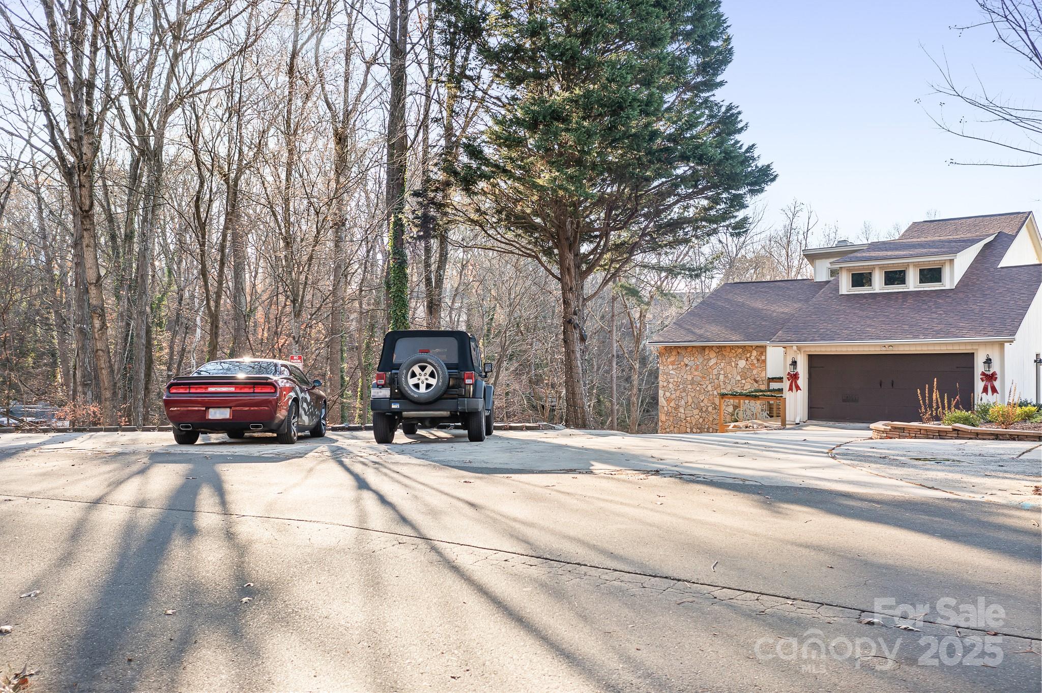 9044 Spanish Wells Court Tega Cay, SC 29708 - Photo 34 of 48 a view of a house with car parked beside of a road