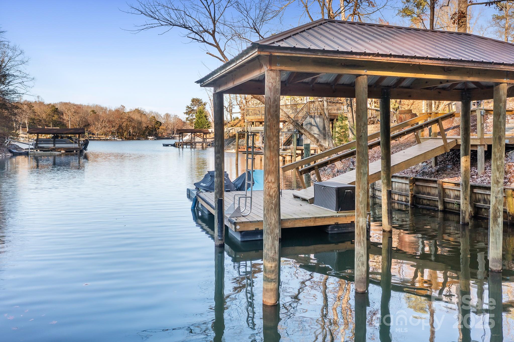 9044 Spanish Wells Court Tega Cay, SC 29708 - Photo 43 of 48 a view of a lake from a house
