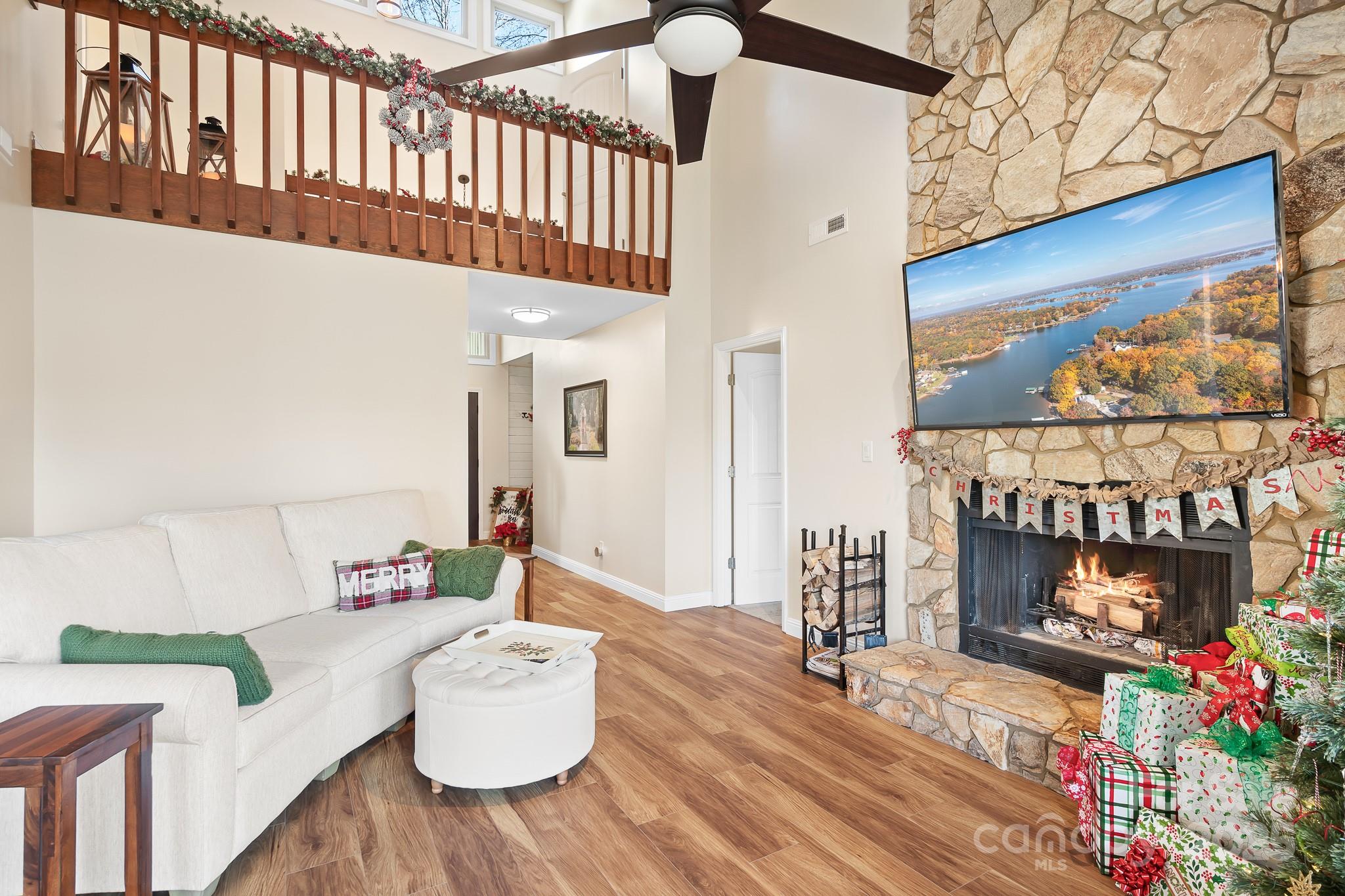 9044 Spanish Wells Court Tega Cay, SC 29708 - Photo 5 of 48 a bedroom with furniture and a fireplace