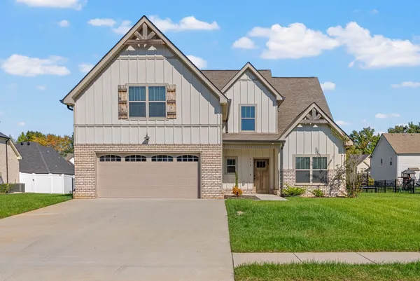 a front view of a house with a yard and garage