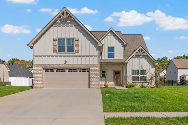 a front view of a house with a yard and garage