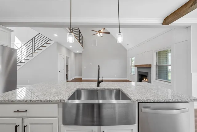 a kitchen with a sink and chandelier