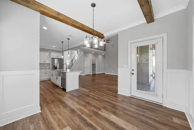 a view of kitchen and hall with wooden floor