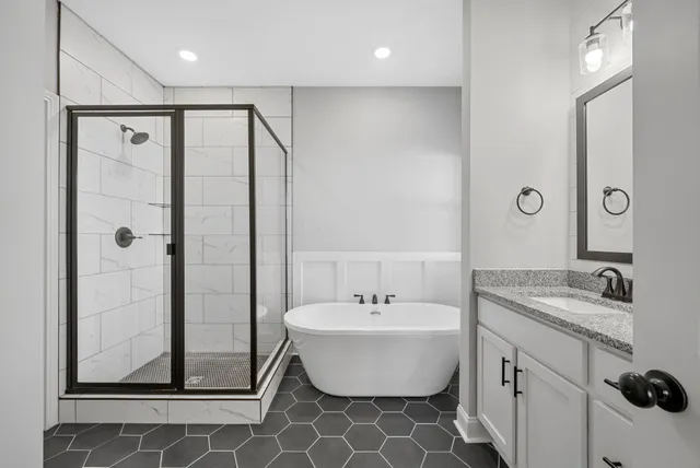 a bathroom with a double vanity sink mirror and shower