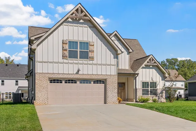 a front view of a house with a yard and garage