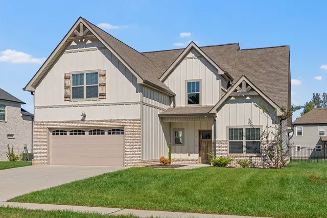a front view of a house with a yard and porch