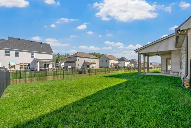 a view of an house with backyard space and garden