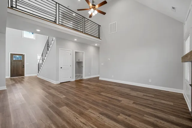 a view of an empty room and wooden floor
