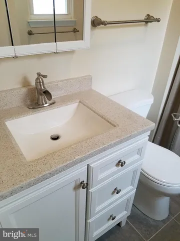 a bathroom with a sink and mirror