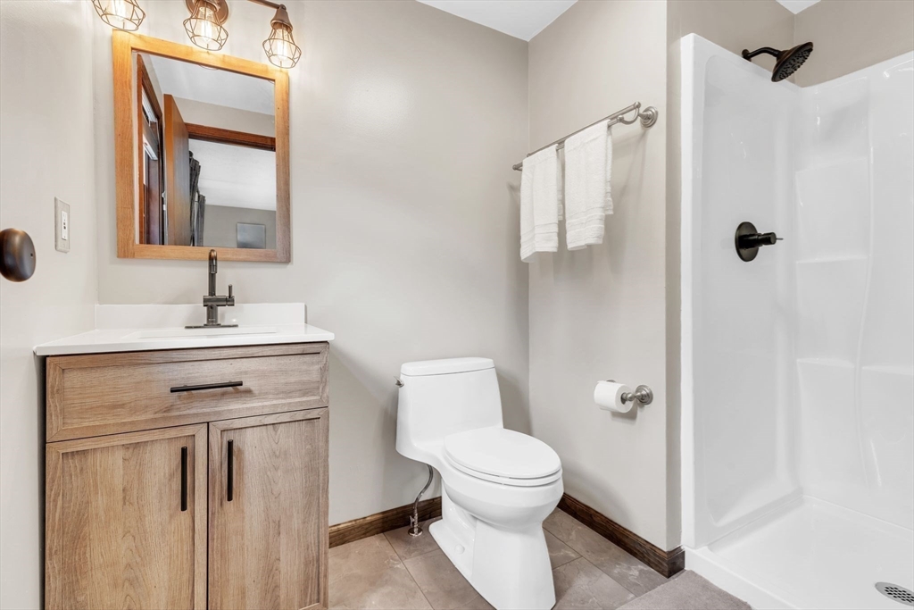 583 Main Road Chesterfield, MA 01012 - Photo 11 of 21 a bathroom with a toilet sink and mirror