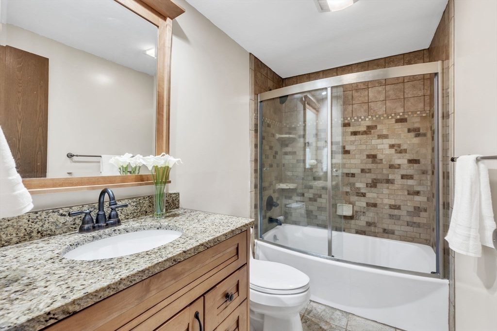 583 Main Road Chesterfield, MA 01012 - Photo 13 of 21 a bathroom with a granite countertop sink toilet mirror and bathtub