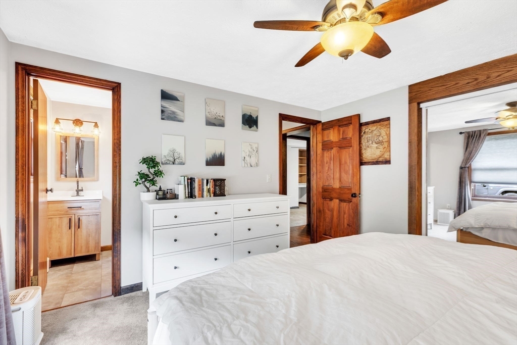 583 Main Road Chesterfield, MA 01012 - Photo 10 of 21 a bedroom with a bed and a chandelier