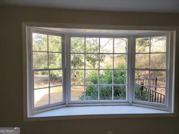 a view of a livingroom with a ceiling fan and window