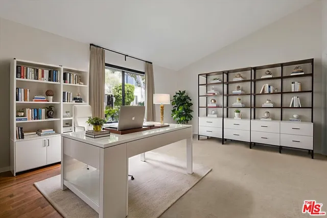a bathroom with a granite countertop sink a toilet a mirror and bathtub