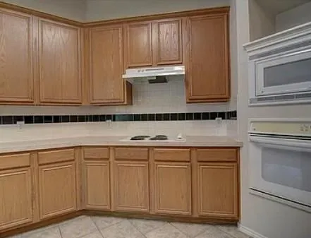 a kitchen with white cabinets and a sink