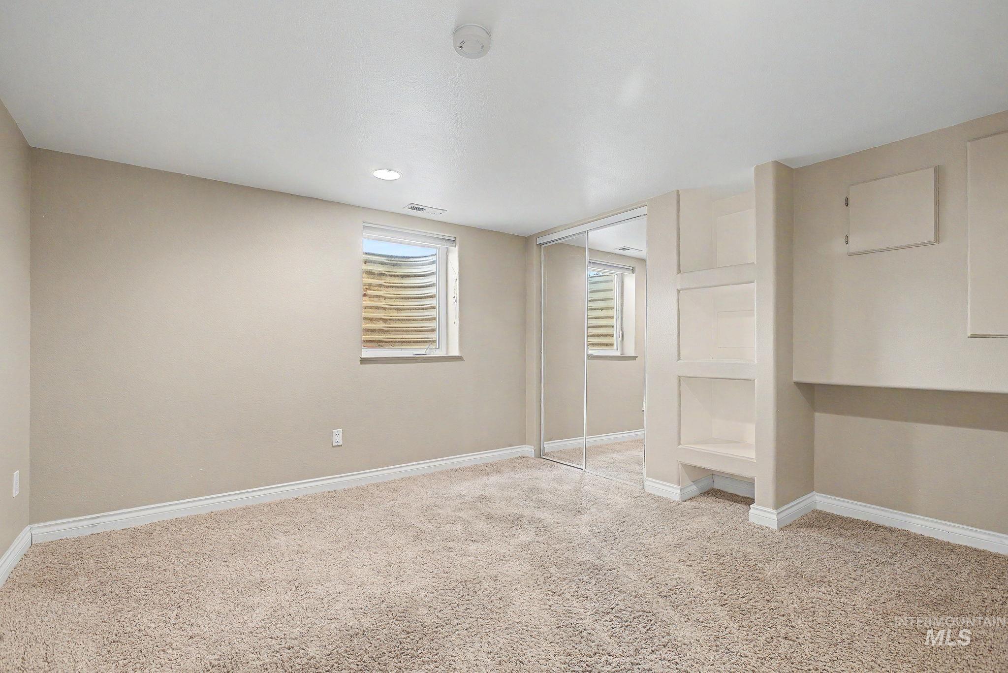 3314 6th Street Lewiston, ID 83501 - Photo 32 of 50 Carpeted room featuring a window, built-in shelving, mirrored closet doors, and recessed lighting