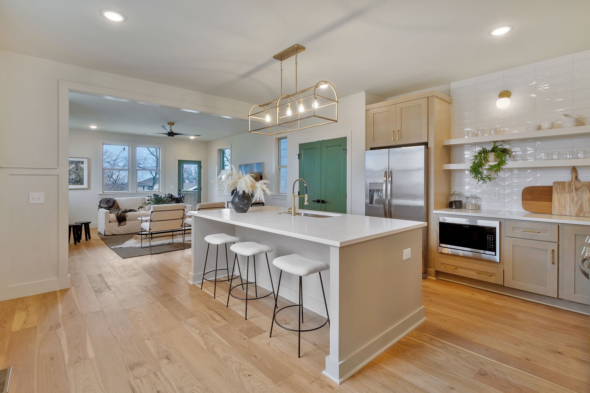 438 Patterson Street Nashville, TN 37211 - Photo 5 of 46 a kitchen with stainless steel appliances a dining table chairs stove and white cabinets