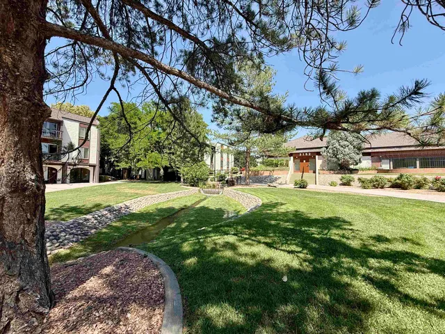 a view of a house with backyard and sitting area