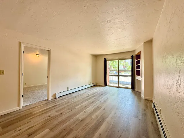 wooden floor in an empty room with a window