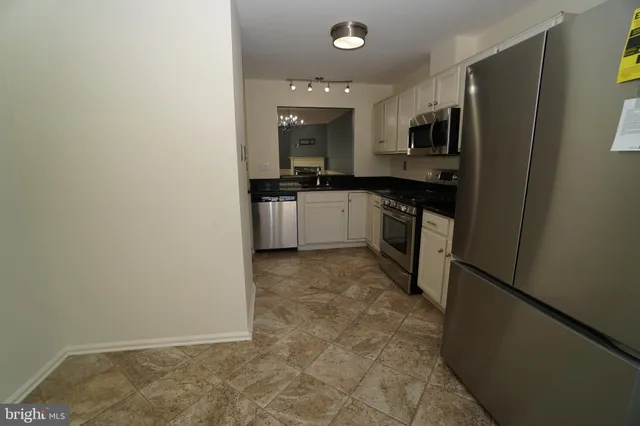 a kitchen with a sink a stove and cabinets