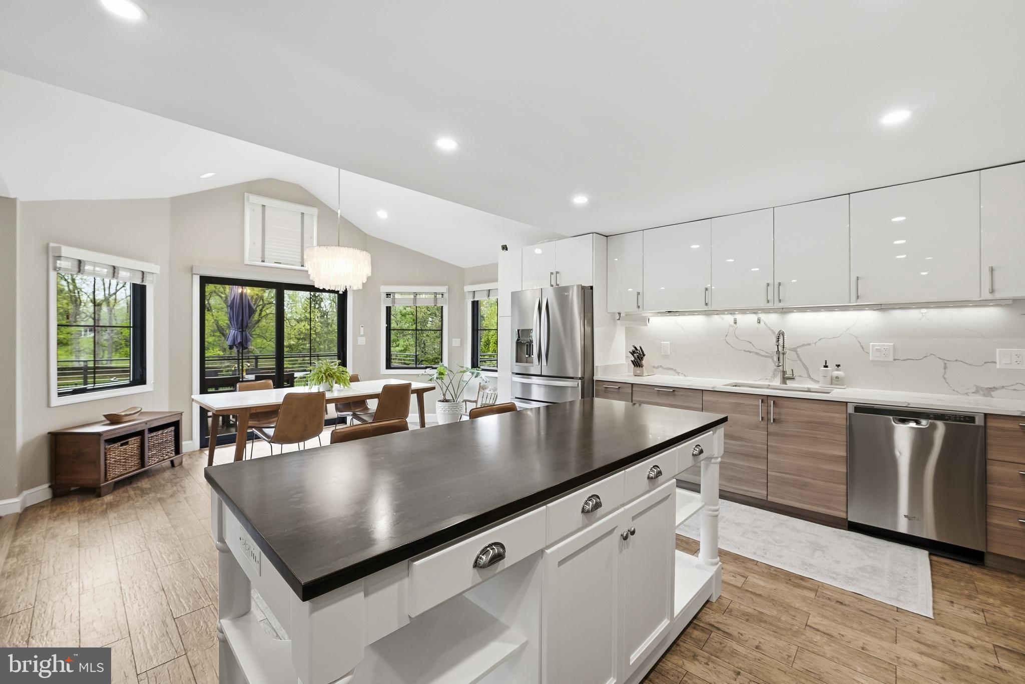 10712 Lockland Road Potomac, MD 20854 - Photo 16 of 66 a kitchen with stainless steel appliances granite countertop a sink a stove and a refrigerator