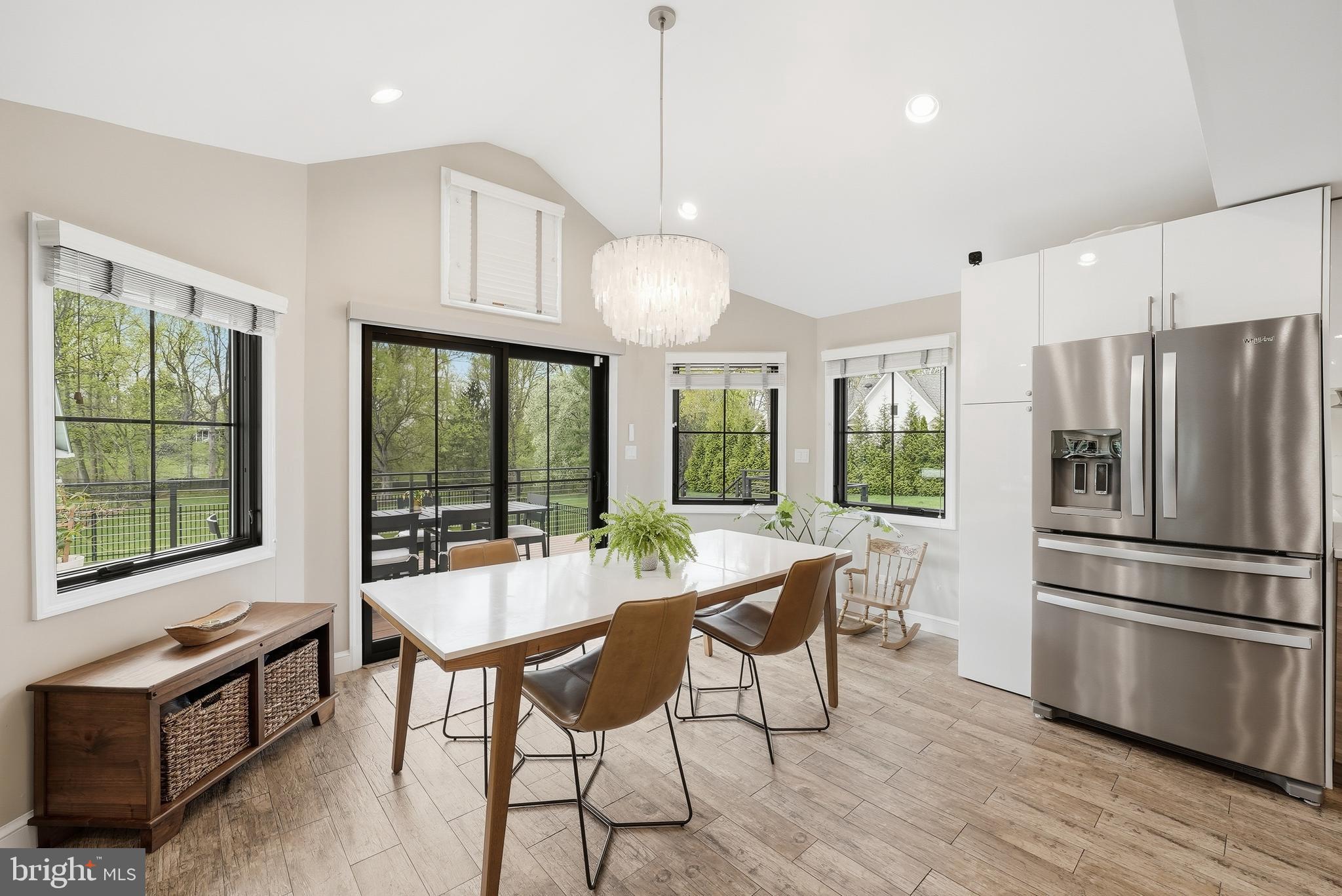 10712 Lockland Road Potomac, MD 20854 - Photo 21 of 66 a dining room with furniture a chandelier and wooden floor