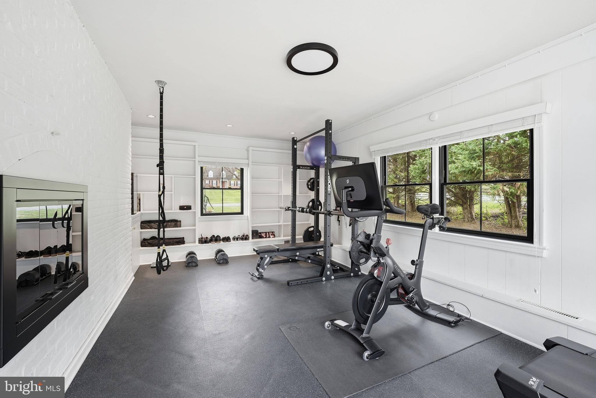 10712 Lockland Road Potomac, MD 20854 - Photo 23 of 66 a living room with furniture gym equipment and a large window