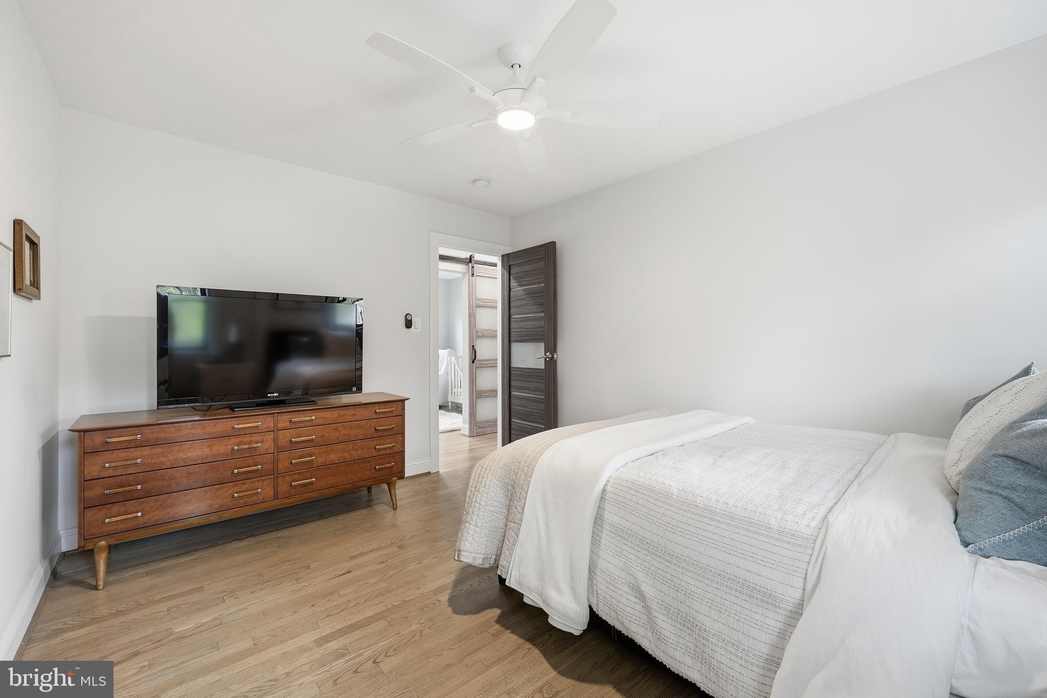10712 Lockland Road Potomac, MD 20854 - Photo 32 of 66 a bedroom with a bed and a flat screen tv