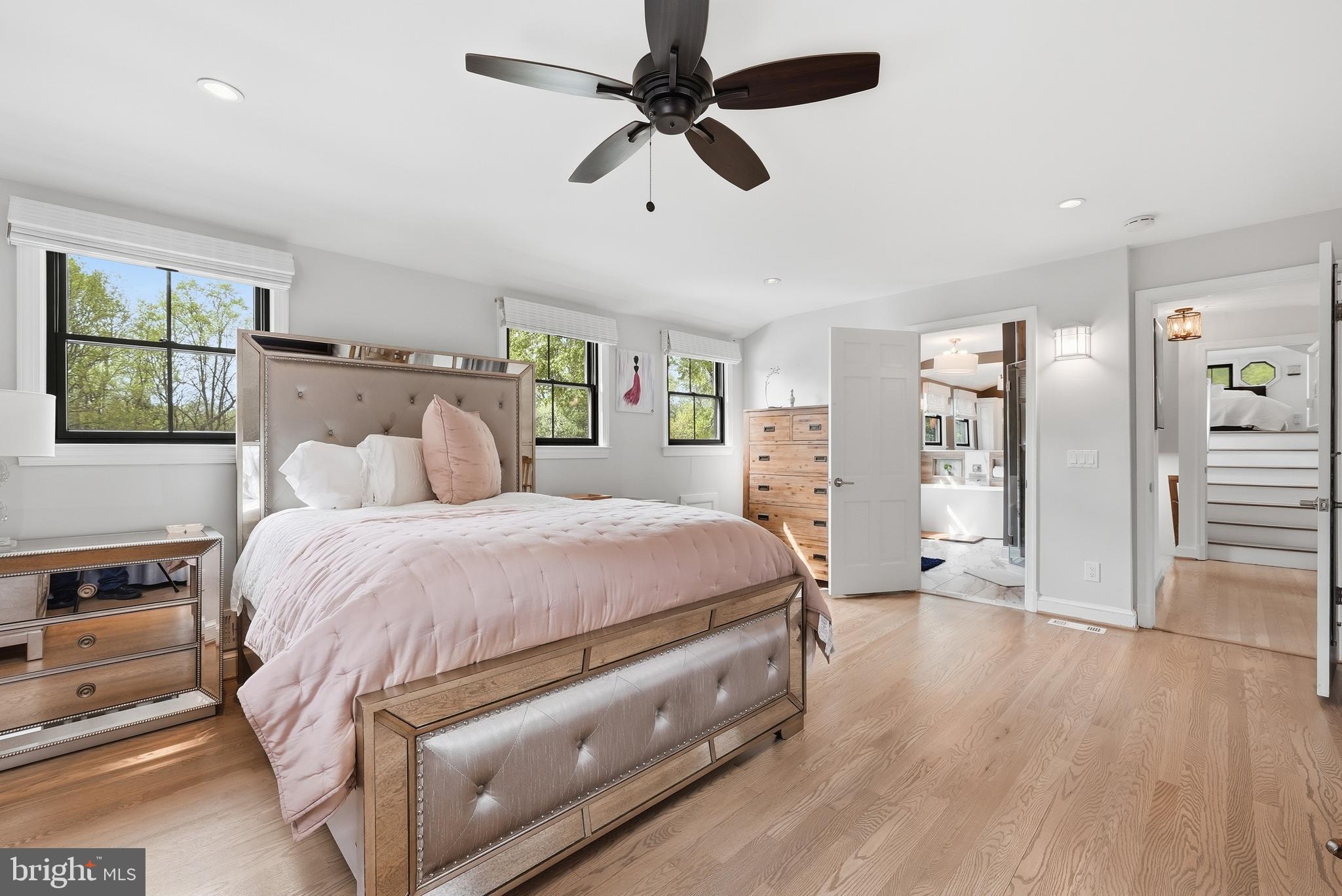 10712 Lockland Road Potomac, MD 20854 - Photo 37 of 66 a spacious bedroom with a bed and a chandelier