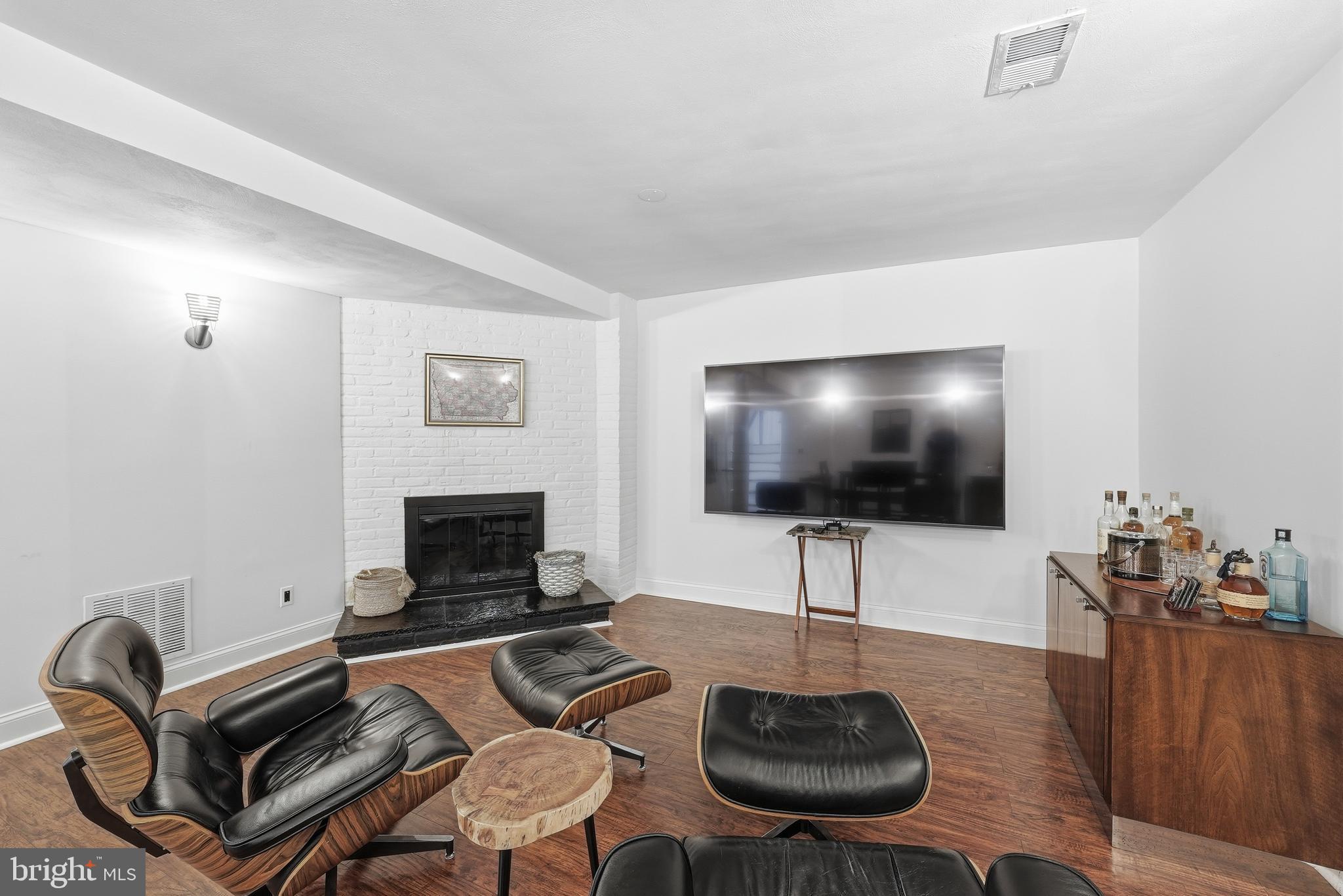 10712 Lockland Road Potomac, MD 20854 - Photo 50 of 66 a living room with furniture a flat screen tv and a fireplace