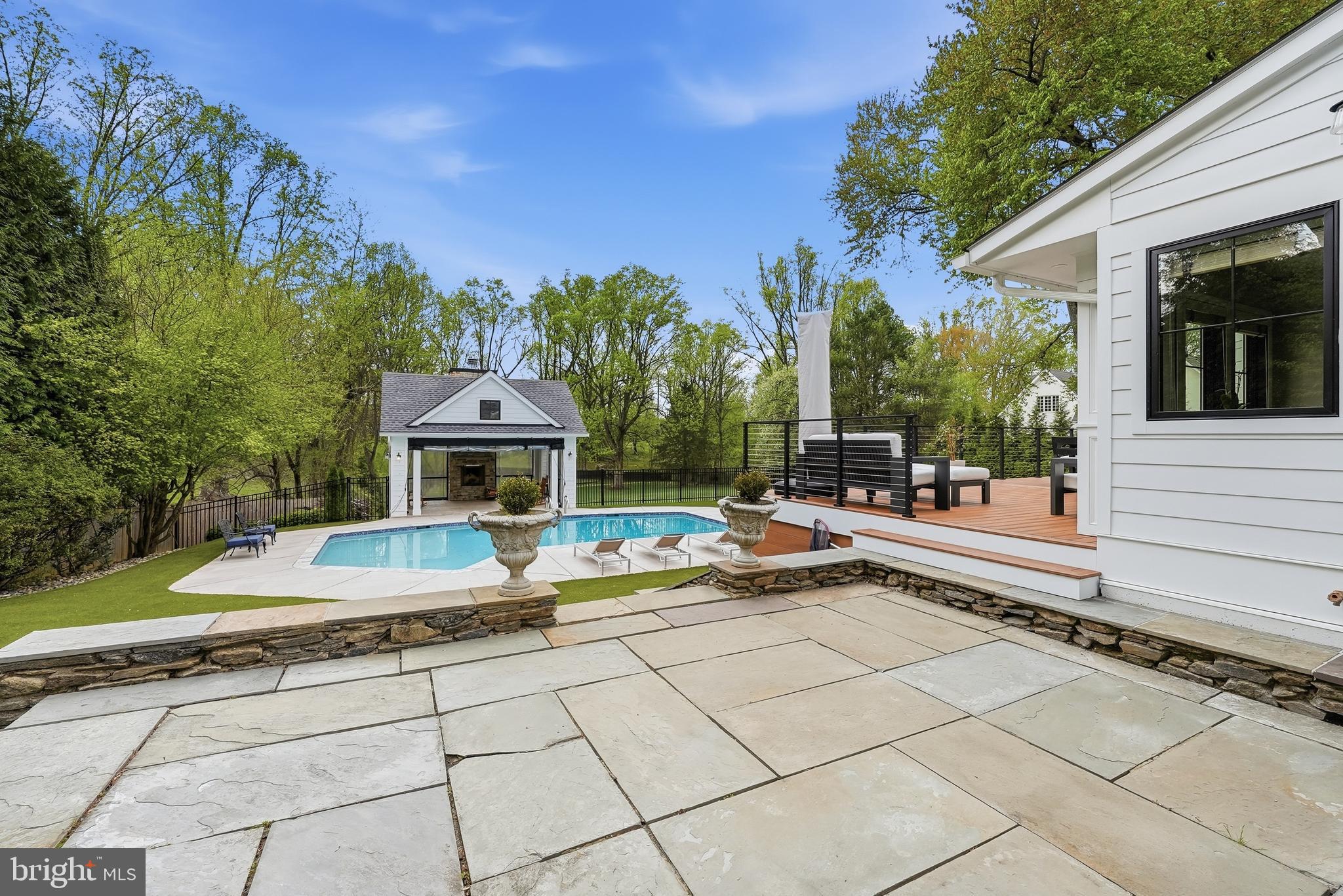 10712 Lockland Road Potomac, MD 20854 - Photo 58 of 66 a view of a patio with dining table and chairs with wooden floor and fence