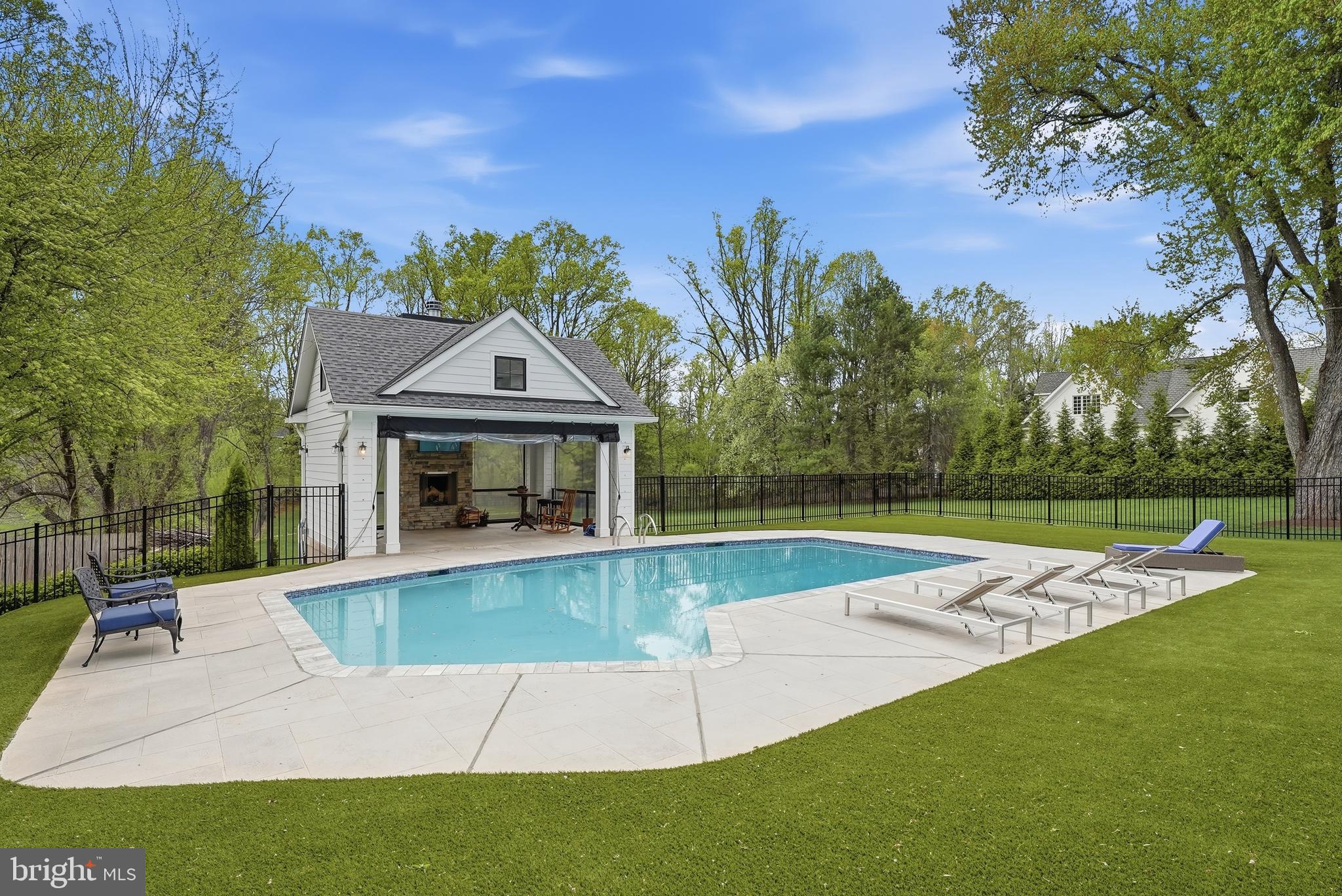 10712 Lockland Road Potomac, MD 20854 - Photo 59 of 66 a view of a house with swimming pool and a yard