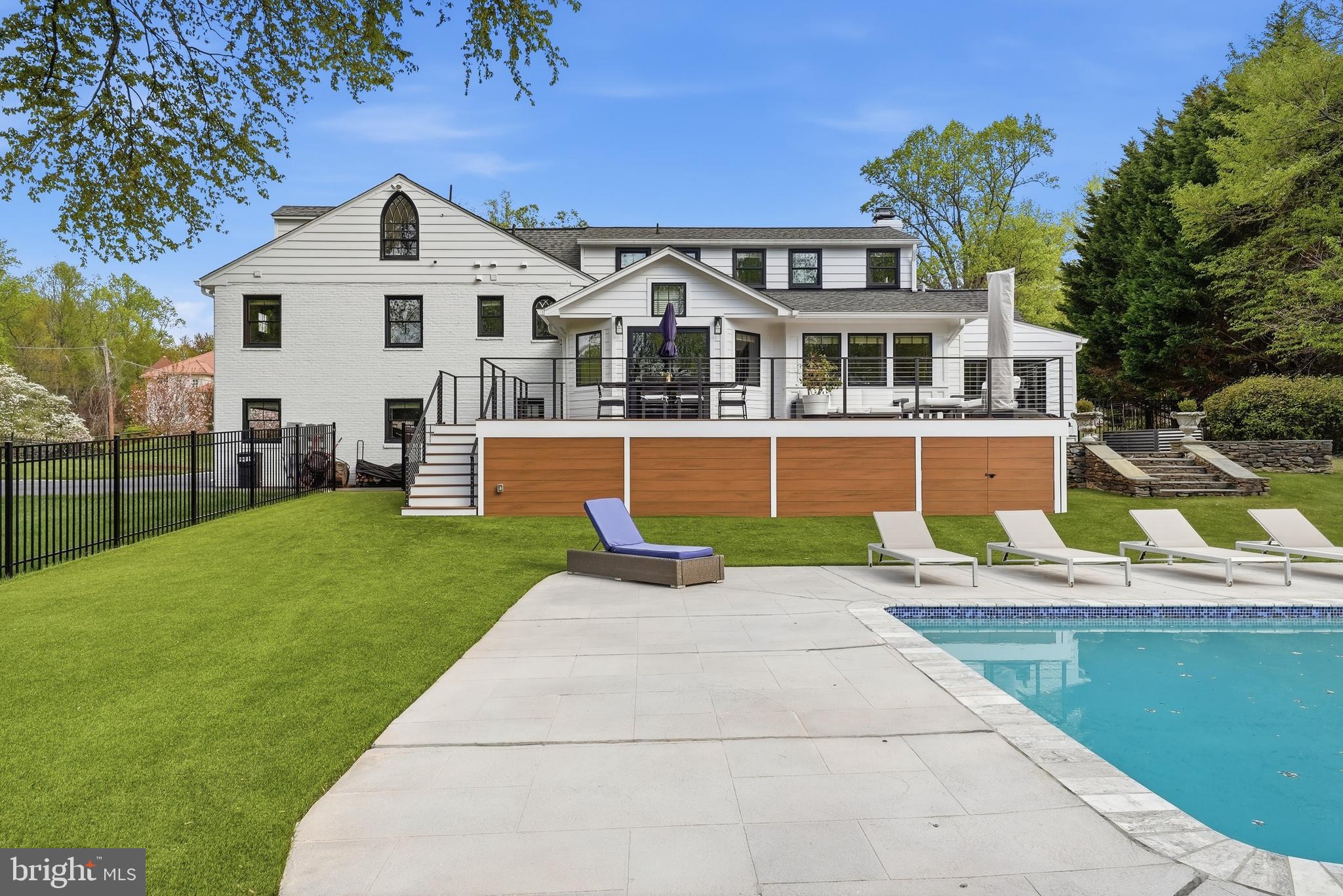 10712 Lockland Road Potomac, MD 20854 - Photo 63 of 66 a front view of a house with a garden and swimming pool