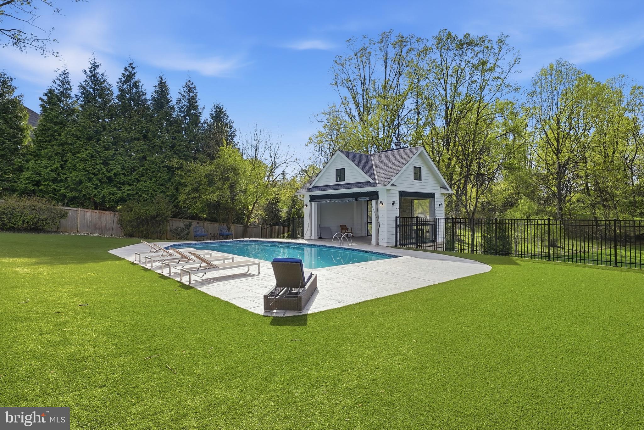 10712 Lockland Road Potomac, MD 20854 - Photo 64 of 66 a front view of a house with a yard garage and outdoor seating
