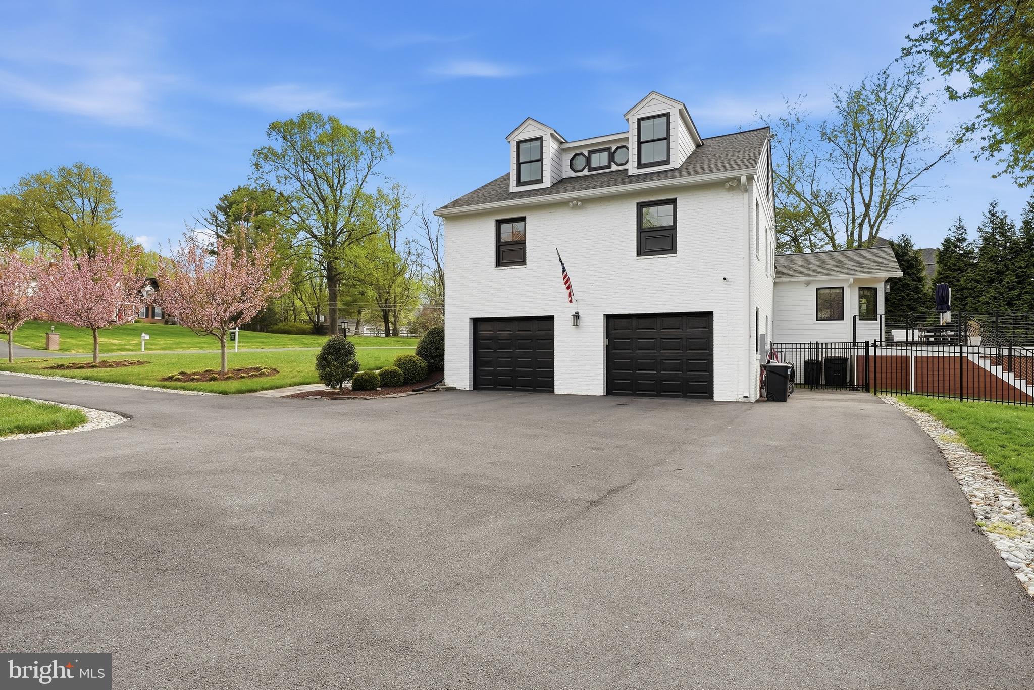 10712 Lockland Road Potomac, MD 20854 - Photo 66 of 66 a view of a house with a yard and garage