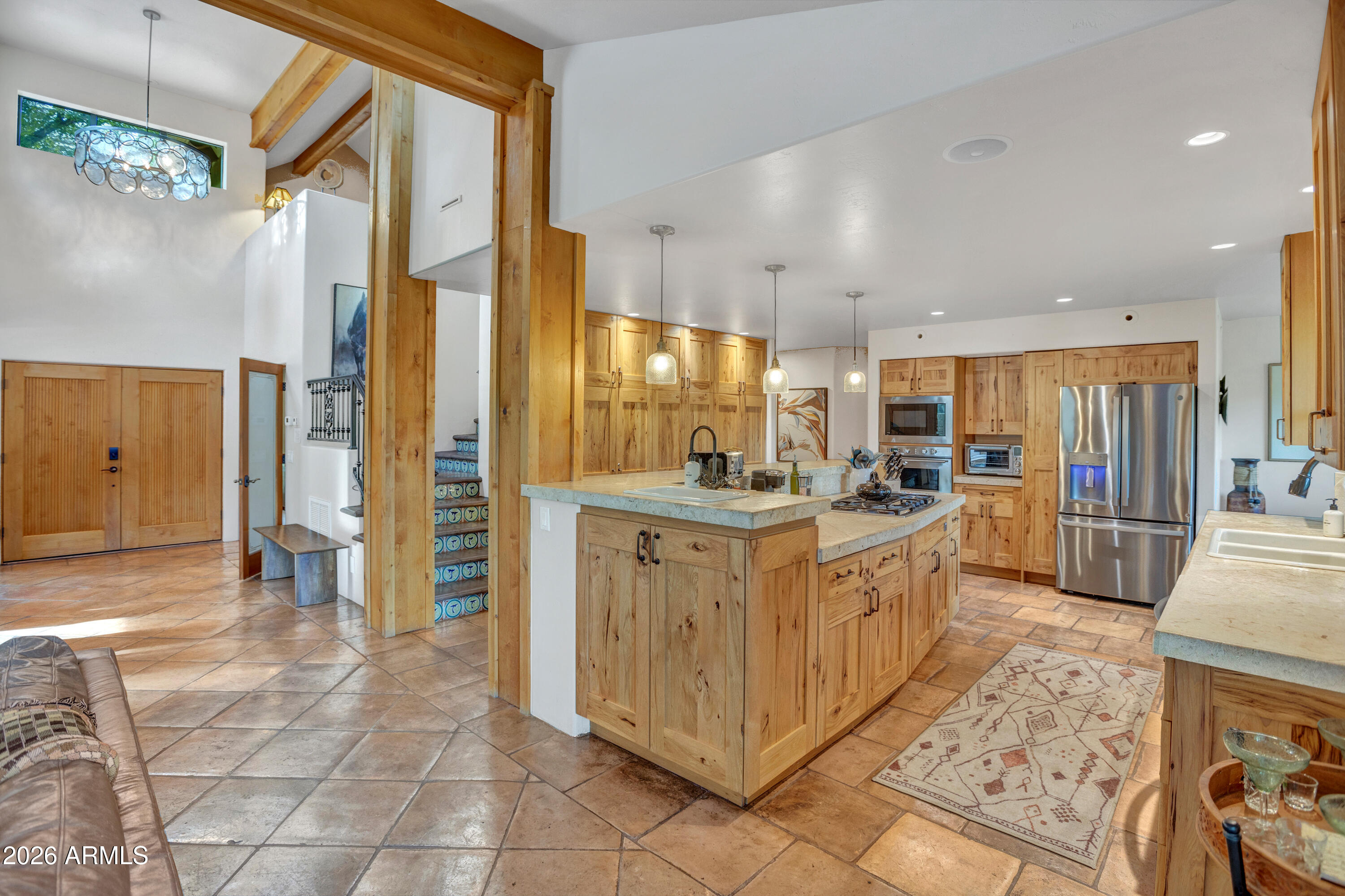 55 Ranch House Circle Sedona, AZ 86336 - Photo 16 of 61 a large kitchen with stainless steel appliances kitchen island granite countertop a refrigerator and a sink