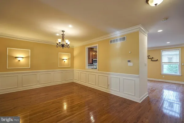 a view of a livingroom with wooden floor and staircase