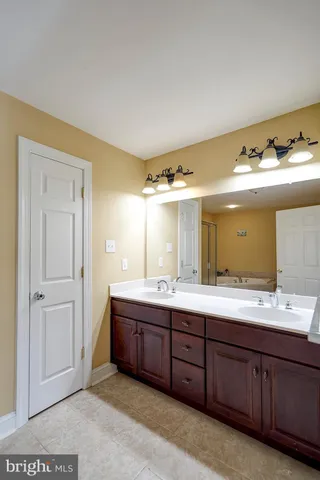 a bathroom with a sink a toilet and a shower