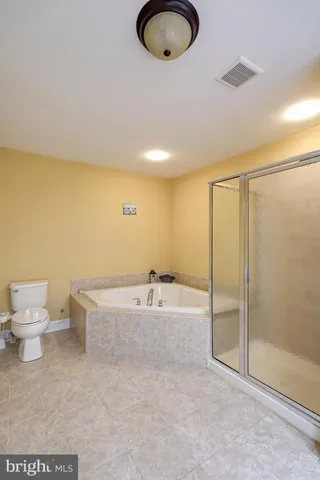 a spacious bathroom with a bathtub and toilet