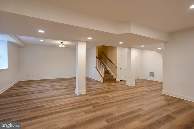 a view of an empty room with wooden floor