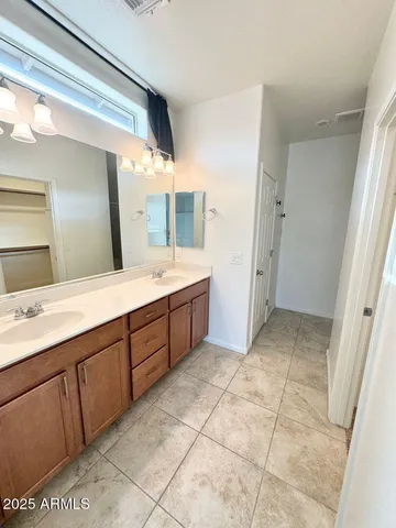 a bathroom with a double vanity sink and a mirror