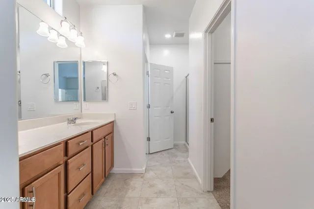 a spacious bathroom with a double vanity sink mirror and double