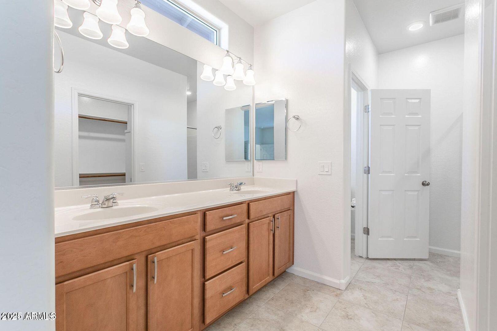 3870 East Balsam Drive Chandler, AZ 85286 - Photo 19 of 39 a spacious bathroom with a double vanity sink mirror and double